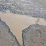 bengalurus-nationalist-pothole-goes-viral:-india-shaped-crater-stuns-residents-on-panathur-balagere-highway