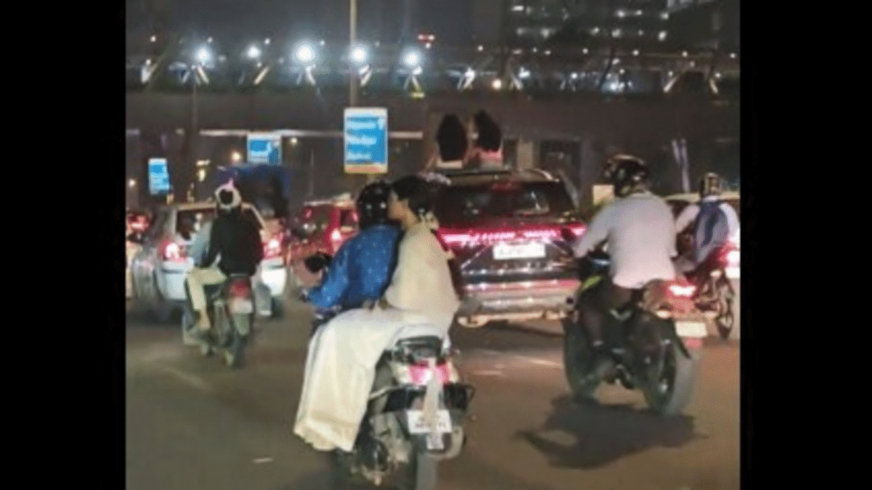 women-sit-on-sunroof-of-transferring-automotive;-video-sparks-outrage-over-highway-security