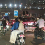women-sit-on-sunroof-of-transferring-automotive;-video-sparks-outrage-over-highway-security